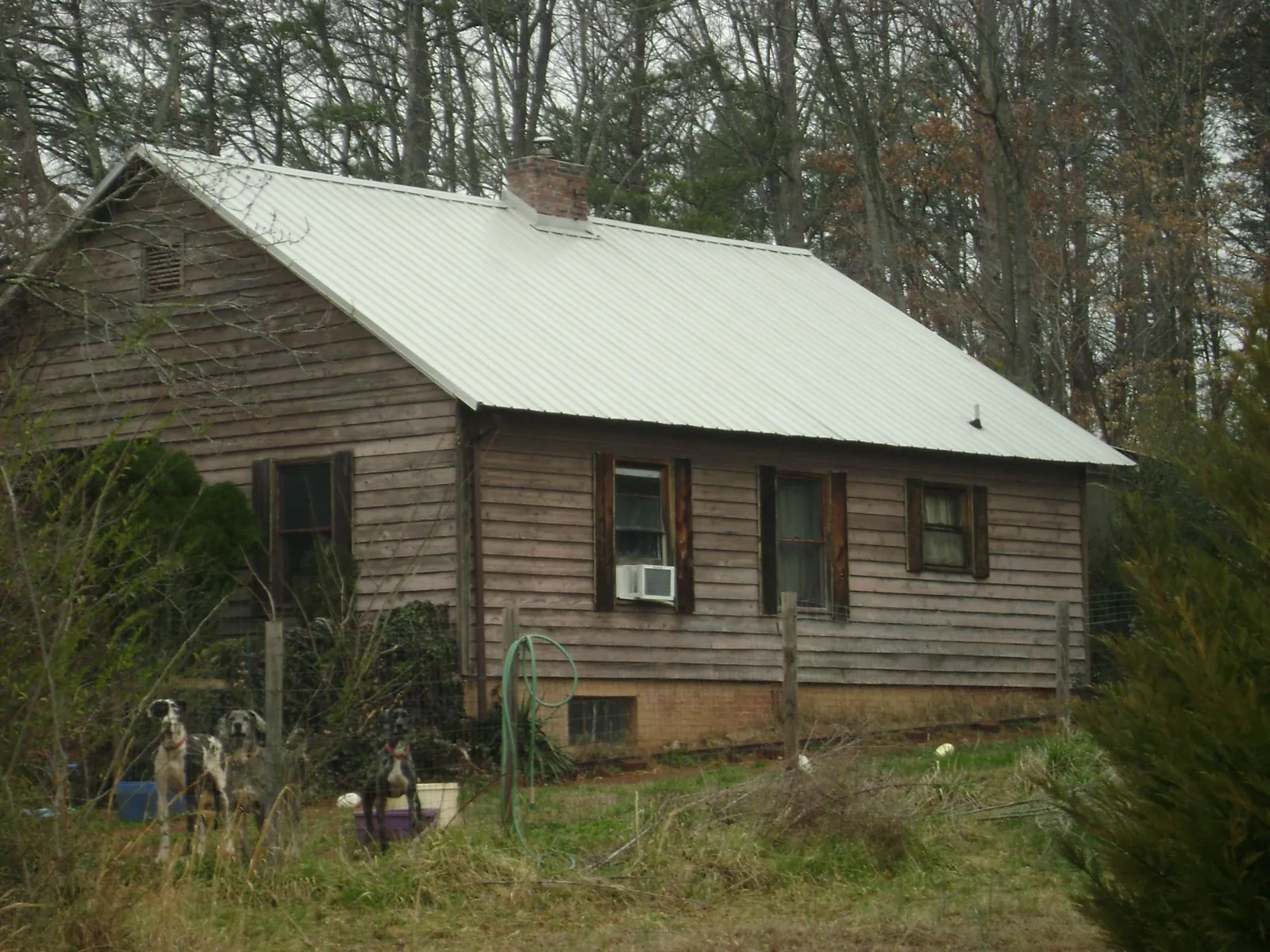 White metal roof on an old wood sided farmhouse, from a Asphalt Shingle Roof Repair job in Newkirk
